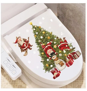 Detail view of festive Santa and Snowman decals applied to a white bathroom toilet lid