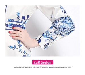 Detail of elegant two-button cuffs on long-sleeved floral satin dress with blue patterns