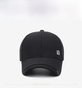 Front view of black cotton baseball cap featuring silver square badge and curved brim