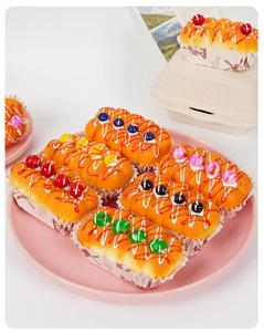 Six assorted slow rising PU squeeze toys shaped like jam cupcakes on a pink tray