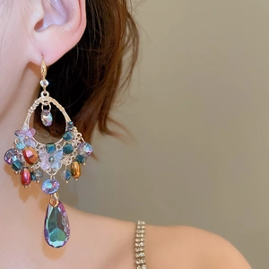 Close-up of bohemian long teardrop earrings with colorful crystals and gold metal hollow design