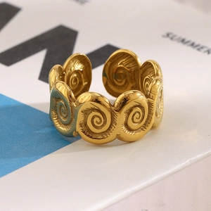 Macro shot of gold-plated stainless steel open ring with continuous spiral shell texture