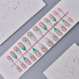 Pink French almond press-on nails set with 3D white floral patterns and green leaf charms
