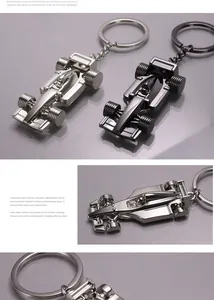 Detailed macro view of F1 racing car keychains in silver and gunmetal zinc alloy finishes