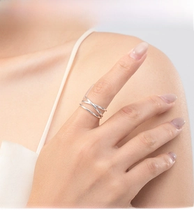 Detail of S925 sterling silver ring featuring a modern triple-layered crossover design