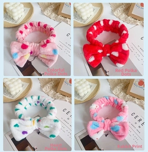 Detail of four plush bow headbands featuring leopard, polka dot, and heart patterns