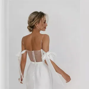 Elegant ivory satin mermaid wedding dress with pearl straps and decorative bow sleeves