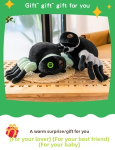 Close-up of plush spider toys with striped legs and embroidered eyes on a wooden table