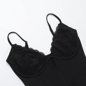 Close-up of black lace patchwork and fine knit texture on sexy lingerie bodysuit