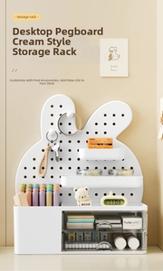 Close-up of white rabbit ear pegboard with multi-layer drawers and hanging shelves