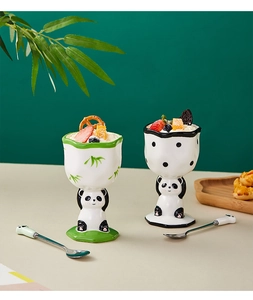 Detail of two panda-shaped ceramic ice cream cups with bamboo patterns and matching spoons