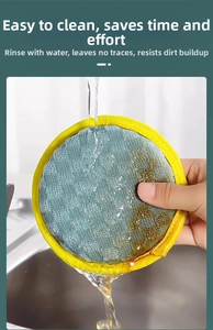 Macro detail of round blue mesh scrubbing sponge under running water in a kitchen sink