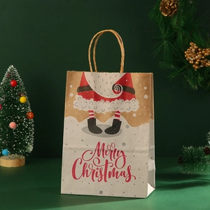 Detail of a brown kraft Christmas gift bag with Merry Christmas text and festive decor