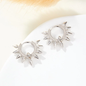 Detailed macro view of S925 silver spiked earrings with sparkling zircon stones