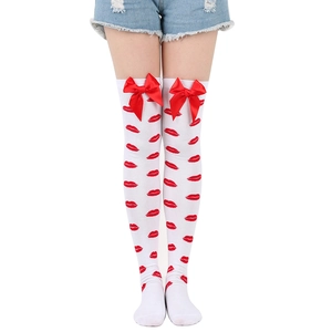 Detail of white over-knee socks with red lip patterns and decorative knit bows