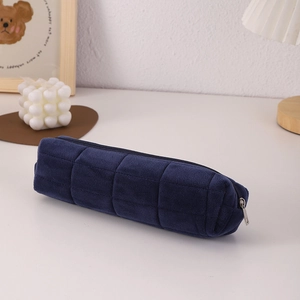 Close-up of dark blue plush stationery pouch with aesthetic quilted grid texture