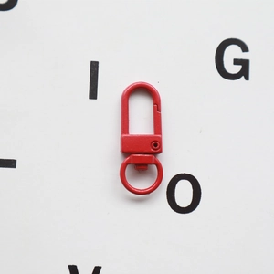 Detail showing red matte finish metal lobster clasp with 360-degree swivel ring