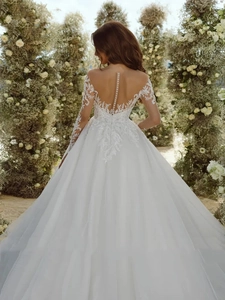 Exquisite white lace ballgown wedding dress with pearl buttons and sheer floral back