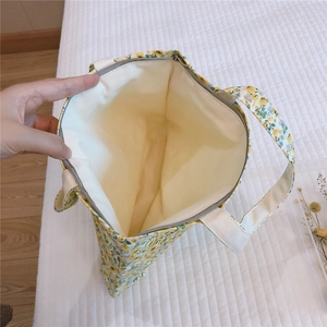 Top view of small floral cotton tote bag showing zipper closure and fabric lining