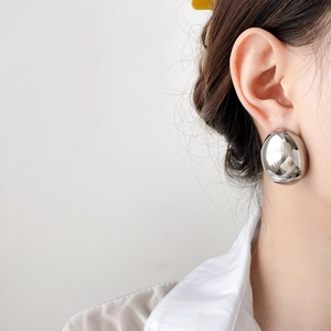 Chunky oversized silver oval stud earrings with high-polished mirror finish surface