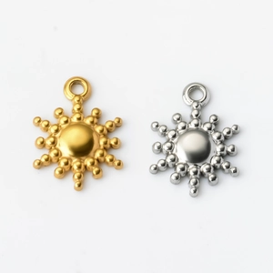 Detailed view of gold and silver sun star pendants in polished stainless steel for DIY jewelry