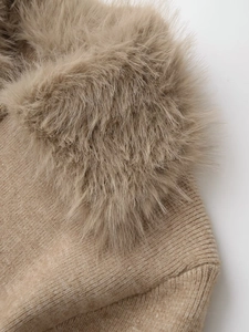 Detailed view of the luxury faux fur collar and knit texture on this camel jacket