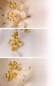 Detail of clover earrings in titanium steel with genuine white freshwater pearls