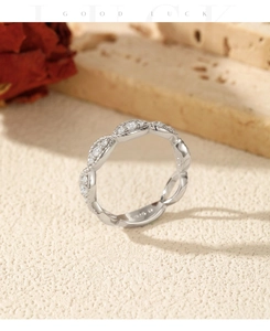 Macro view of S925 silver braided ring featuring sparkling moissanite stones and engravings