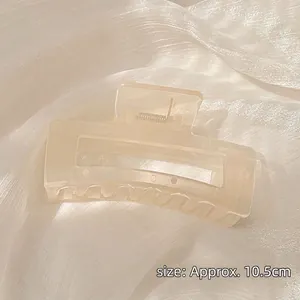 Detail view of a 10.5cm matte cream resin hair claw clip with a durable silver spring