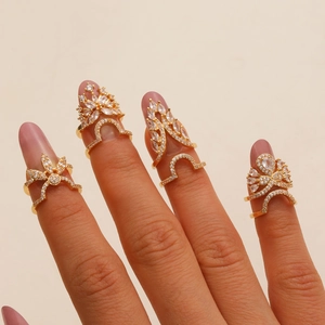 Detailed view of four piece copper zircon nail ring set featuring floral and feather designs