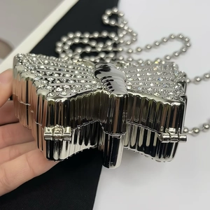 Detail of silver butterfly evening bag with sparkling rhinestones and metal chain strap