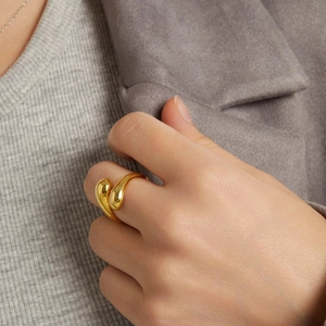 Detail of 18k gold plated stainless steel teardrop ring on finger for modern style