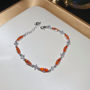 Detail of a marquise orange gemstone bracelet with white zircon inlay on silver chain
