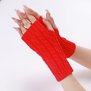 Detail showing red cable knit texture and thumb hole on the warm fingerless gloves