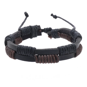 Close-up of vintage braided leather bracelet with black and brown handmade wax cord details