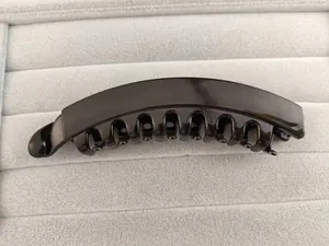 Detailed close-up showing the curved teeth design of the glossy banana hair clip for women
