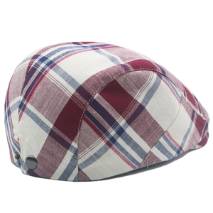 Detail of adjustable metal buckles and red-blue plaid fabric on cotton beret cap