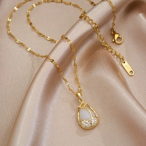 Elegant 18K gold tulip necklace with cat eye stone and diamonds on champagne silk