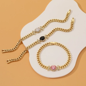 Luxury gold Cuban chain bracelets with oval gemstone settings and pavé diamond accents