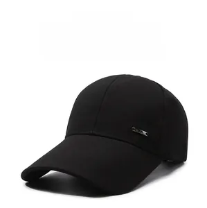 Close-up of black cotton baseball cap showing side silver metal plaque and stitching