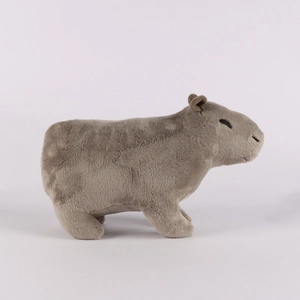 Side profile of a cute plush capybara toy with realistic soft brown fur on white background