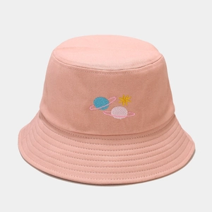 Detailed close-up of pink cotton bucket hat with colorful planet and star embroidery