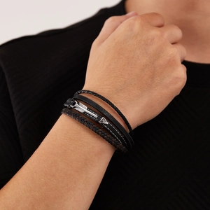 Men's multilayer braided black leather bracelet with silver feather charm on wrist