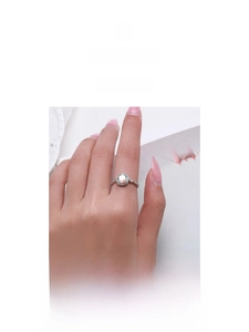Detail of S925 sterling silver ring with sparkling round zircon and twisted band