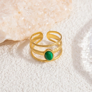 Close-up of layered gold stainless steel ring featuring a polished green natural stone