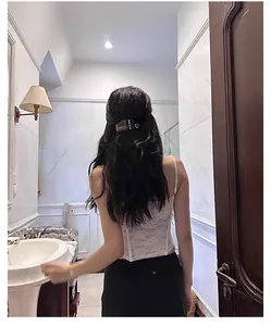 Rear view of a model wearing a French vintage black heart hair clip on a ponytail