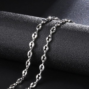 Macro view of polished 4.5mm silver stainless steel coffee bean link chain jewelry