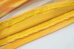 Gros plan détaillé du tissu en maille jaune avec coutures de finition précises