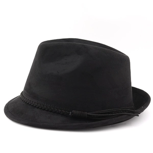 Detail of black suede cowboy hat featuring a braided band and tassel on white background