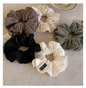 Detail of 5-piece knitted scrunchie set in assorted colors with soft crochet texture